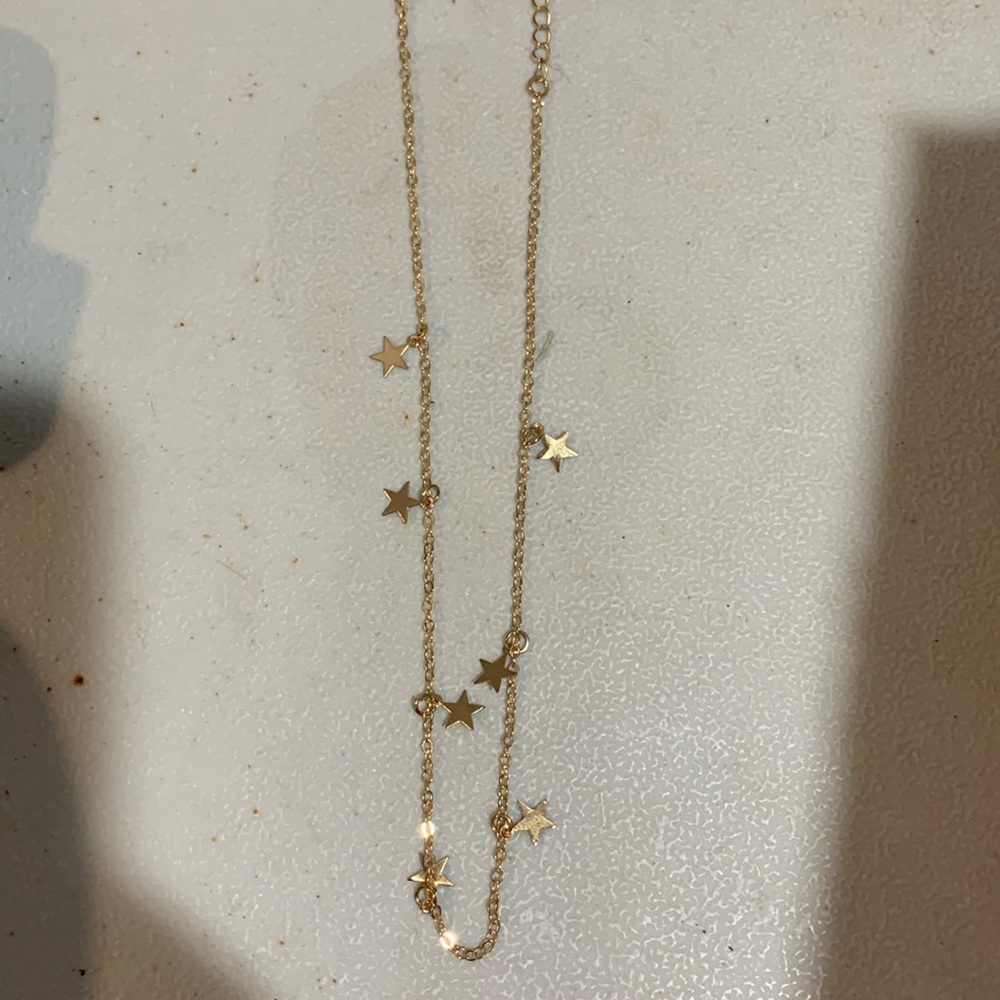 Gold colored star necklace in box NWOT